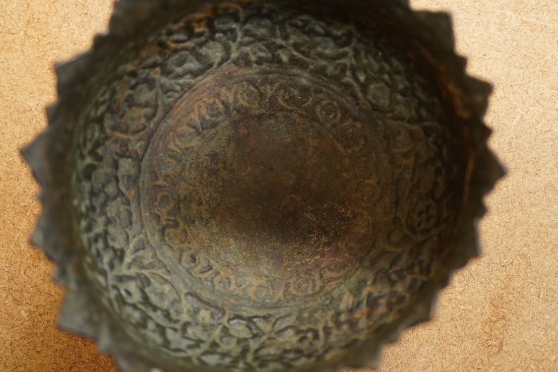 A 19th century Kashmiri base metal repousse bowl , with foliate border, diameter 10.8cm.